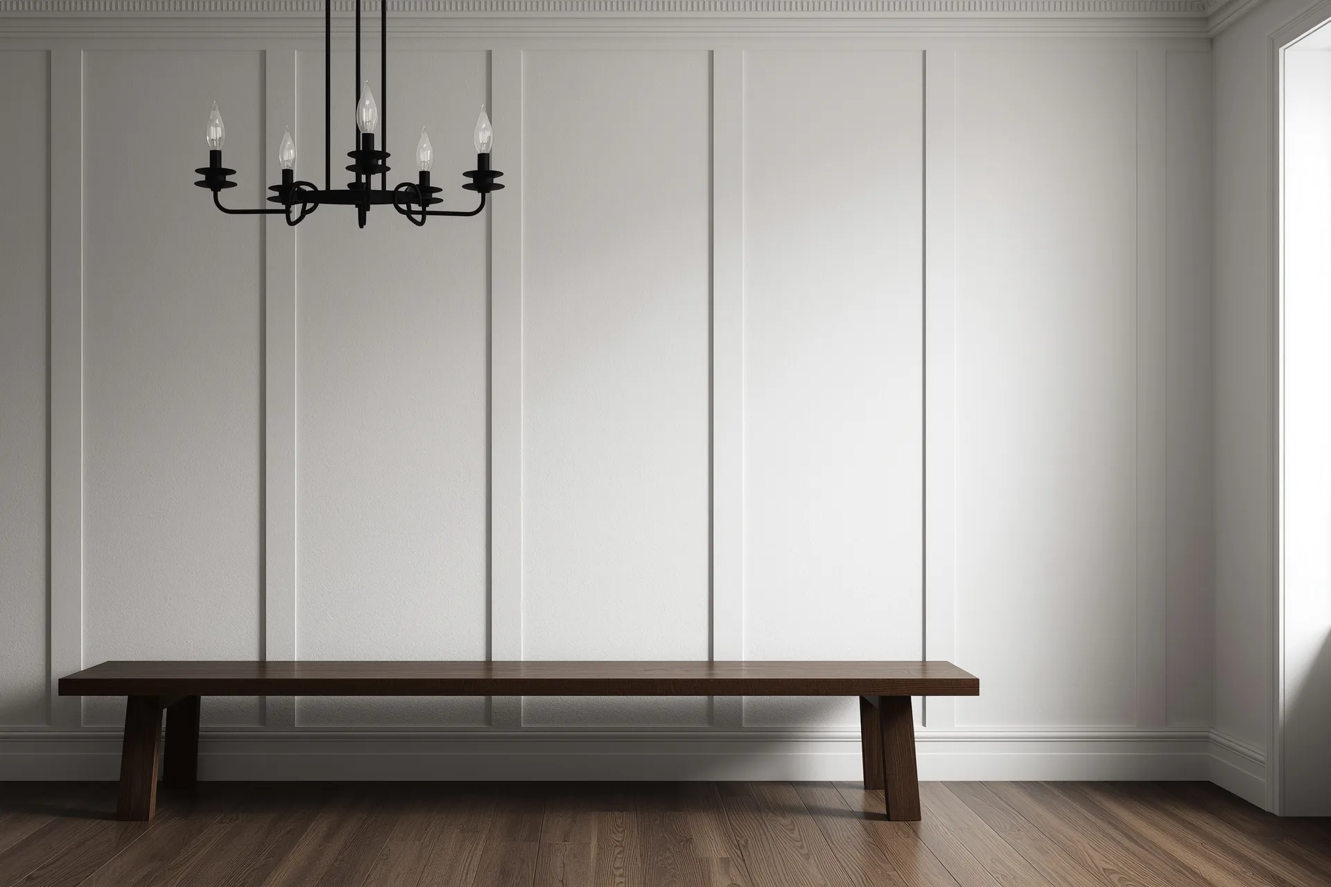 Matte black candle-style chandelier reading as a line drawing on white walls, black echoed in chair frames over oak